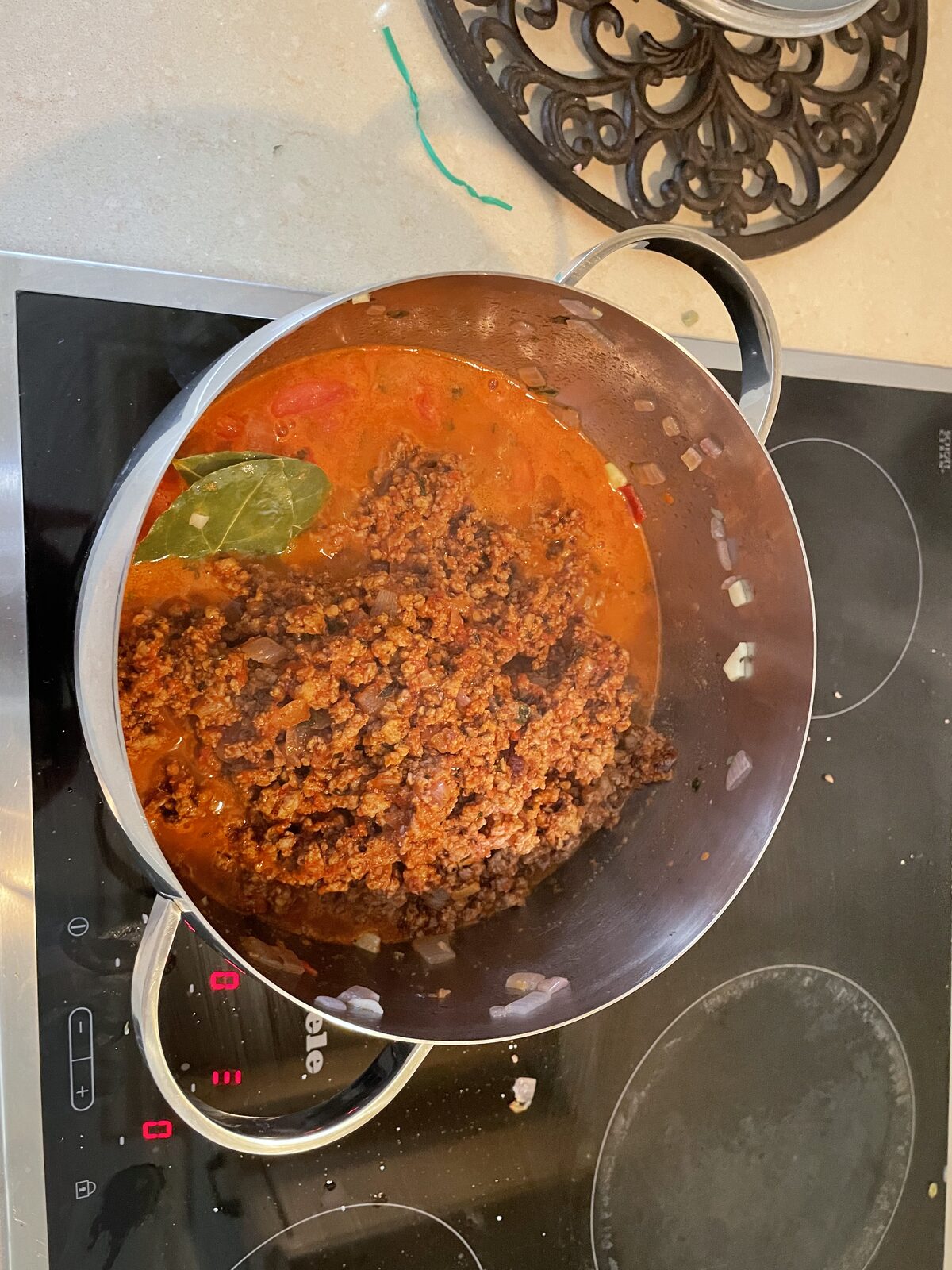 The combined ragù simmering in the large pot