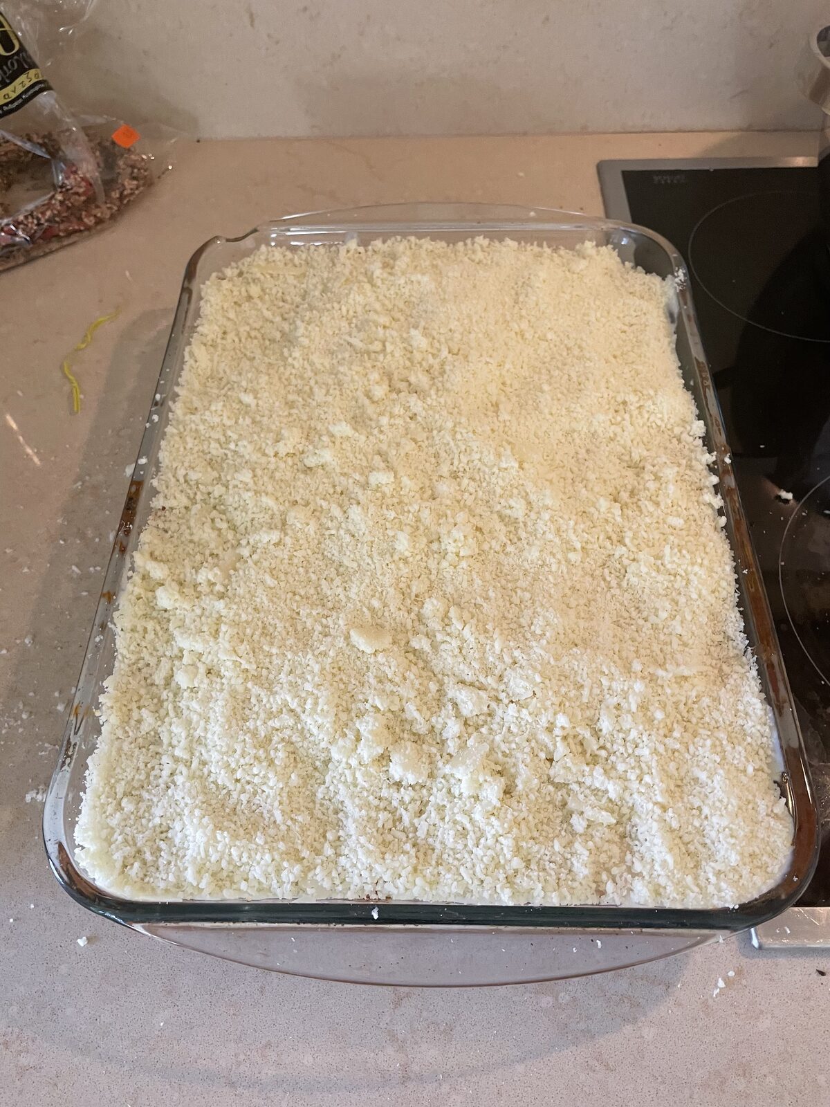 A thick layer of grated Gruyère covering the béchamel
